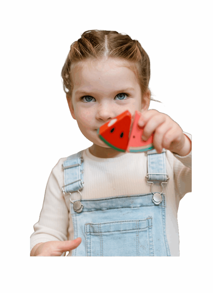 girl playing with watermelon toy at daycare
